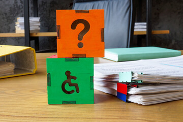 Inclusive workplace. Disabled person sign on desk.