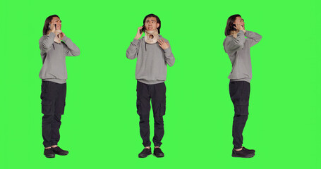 Obraz premium Person with neck collar brace answers call on mobile phone, talking to friends about his bone fracture incident. Hurt man wearing cervical foam chatting on telephone line, greenscreen.