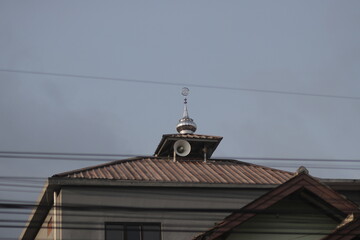 Old white speaker in the corner of an old mosque in a rural area in Indonesia