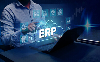 ERP Cloud System Software Automation: A businessman analyzes Enterprise Resource Planning (ERP) software or applications on a virtual screen using his laptop.