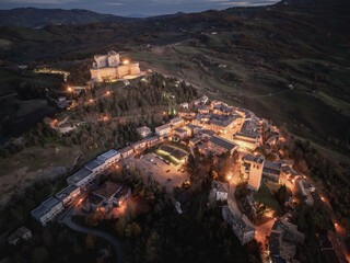 Italy November 24, 2024: aerial view of the village of San Leo with its fortress at sunset. We are...