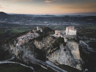 Italy November 24, 2024: aerial view of the village of San Leo with its fortress at sunset. We are...