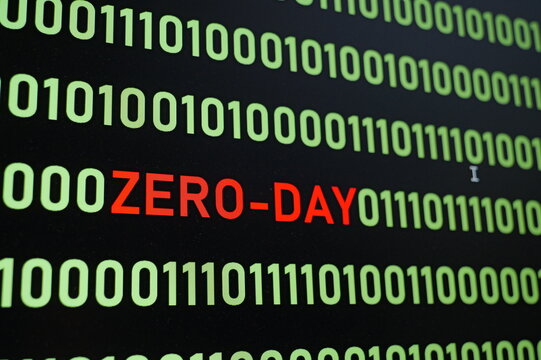 ZERO-DAY text and binary code concept from the desktop computer screen,ZERO-DAY vulnerability concept (also known as a 0-day)A zero-day vulnerability is a flaw in software or hardware.