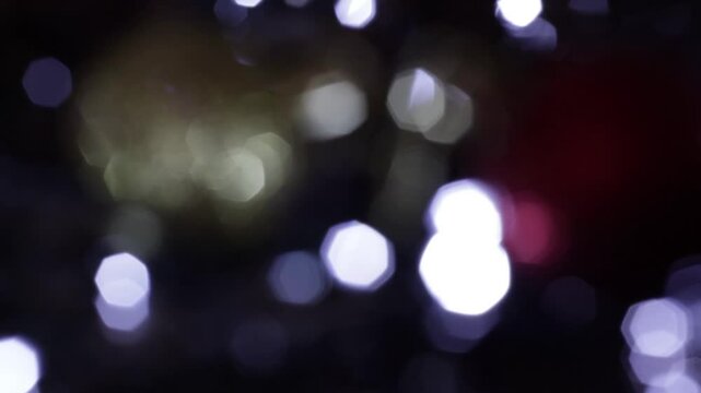 Una toma de cerca de varias luces de colores en forma de c&iacute;rculos en movimiento en la oscuridad. Desenfoque, efecto Bokeh
