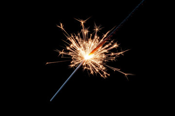 Obraz premium Lit sparkler with bright golden sparks