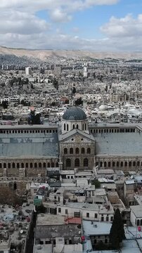 Wide view of the Great Umayyad Mosque Damascus city and Mount Qasioun, vertical video.