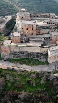Krak des Chevaliers castle Syrian historical landmarks aerial view, vertical video.