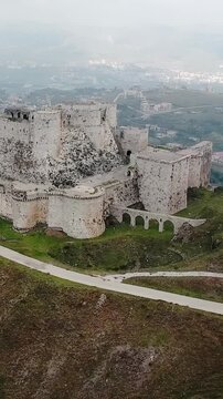 Krak of the knights castle Krak of Chevaliers Homs Syria mountain landscape, vertical video.