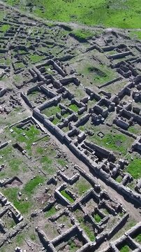 Wide aerial view of the ruins of the ancient Ugarit port city in Syria, vertical video.