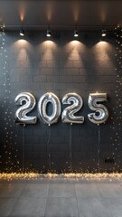 Silver "2025" balloons with fairy lights on dark wall