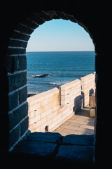 View through the window of the beginning of the Great Wall of China, known as the Old Dragon's Head, on a sunny day, Qinhuangdao, China