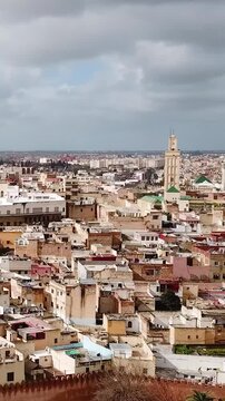 Meknes City skyline and houses Morocco semi-cloudy sky travel aerial footage, Vertical Video.