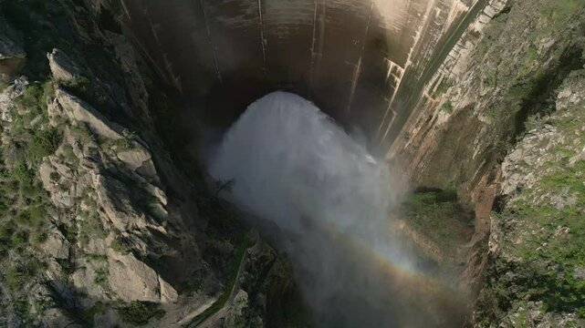Dam discharges water from the reservoir. Arial view dolly out of water outlet from the dam. Howell Bunger valve in operation in vault dam. Quentar Reservoir. Spain.
