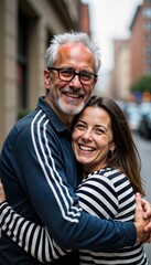 Obraz premium Affectionate couple hugs warmly on city street. Smiling man, woman embrace showing happiness, love. Casual attire. Outdoor urban setting. Portrait style photo shows bonding, togetherness. Couple