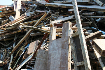 A large pile of discarded wood and construction debris. Various sizes and types of debris wood....