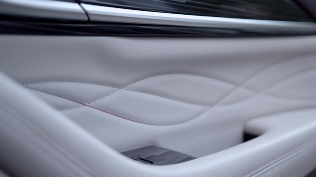 close up view of the white leather door trim of a luxury car.