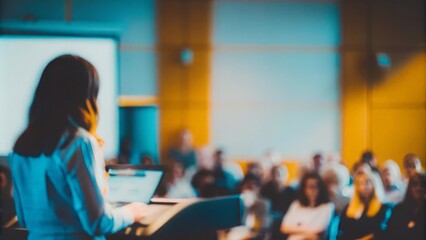 "Public Speaker at Event Blur": Female speaker at a conference, with audience blurred behind her.
