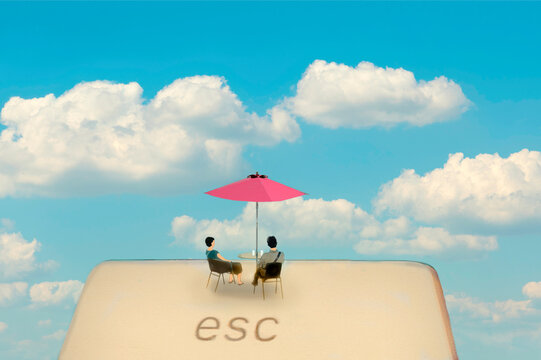 Illustration of couple sitting under parasol on oversized escape key
