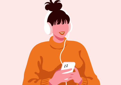 Young woman listening music with mobile and headphones against pink background