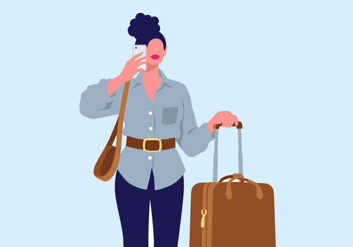 Woman with purse and suitcase talking on phone against blue background