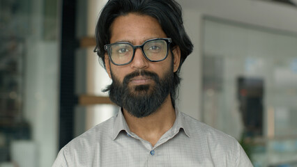Obraz premium Close-up indian confident businessman looking at camera arabian bearded man entrepreneur professional sales manager leader financial advisor lawyer executive ceo posing indoors male business portrait