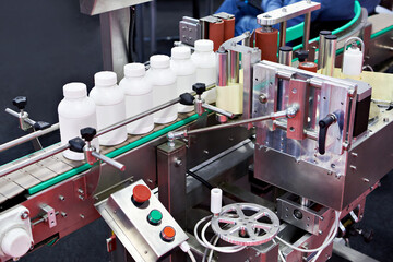 Machine for labeling plastic tubes