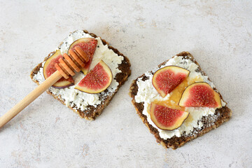 a sandwich with sliced figs, cheese and honey top view