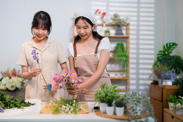Two florists sharing a joyful moment while arranging flowers in a vibrant and organized workspace...