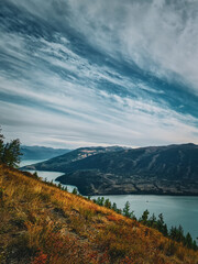 Obraz premium kanasi lake landscape or mountain view, scenery of mountain in China, travel destination or tour tourism, xinjiang, majestic panorama nature view. destination, blue sky, hill top, calmness.
