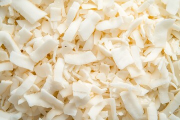 Shredded Coconut Flakes, Close-Up Focusing on Their Light, Fluffy, and Fine Texture. Great for Desserts, Ingredient Advertisements, or Healthy Snack Campaigns.