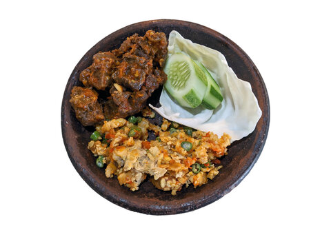 Paru Balado with spicy vegetable salad, and sliced cucumber on a cobek or plate made from clay. This is an traditional Indonesian menu for lunch or breakfast.