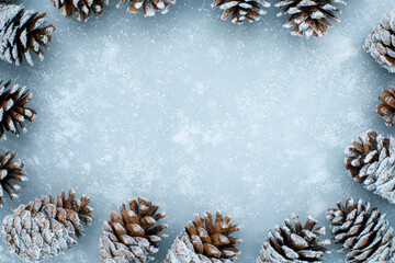 Frosted Pinecone Wreath Decorated with Snowfall Backdrop for Christmas Festivities and Holiday Celebrations