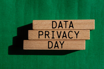 Data privacy day message written on wooden blocks with green background. Conceptual data privacy day symbol. Copy space.