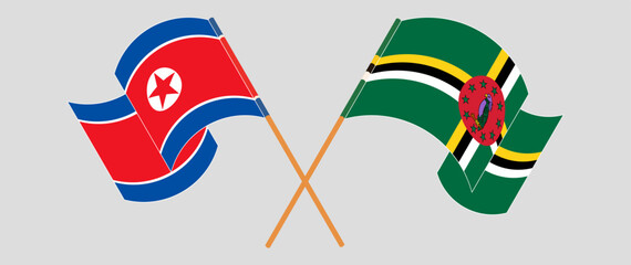 Crossed and waving flags of North Korea and Dominica. Vector illustration