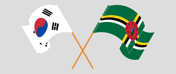 Crossed and waving flags of South Korea and Dominica. Vector illustration