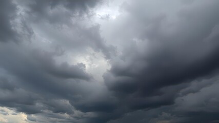 Fototapeta premium Dark stormy clouds gathering in the sky, creating a textured and dramatic atmosphere, atmosphere, gathering