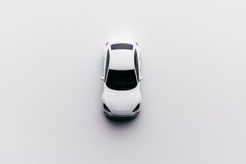 Aerial view of a sleek grey car against a pure white backdrop, featuring gray and white 
