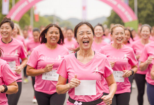 Women running in pink for breast cancer awareness marathon