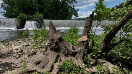 Beautiful waterfall on warm summer day on James River at Lynchburg, VA historic southern town green trees blue sky with clouds