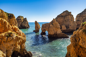 Fototapeta premium Ponta da Piedade is a unique rock formation with famous grottos in the ocean at Lagos, Algrave, Portugal