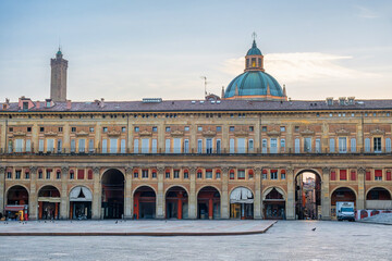 Piazza Maggiore in Bologna old town, Emilia Romagna, Italy with Palazzo dei Banchi with arched porticoes and Dome of the Basilica of San Pietro at sunrise with nobody. Travel destination in Europe © samael334