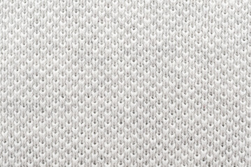 Texture of white material or fabric with interlaced lines in the shape of rhombuses. Gray background