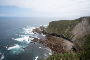General view of the cliffs of Cabo Vidio, in Asturias, with the sea calm and the sky cloudy
