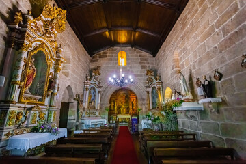 Fototapeta premium Vila Nova de Famalicao, Portugal. Santiago de Antas church interior. High-altar and pews. Rota do Romanico or Romanesque Route travel. 13th century medieval Romanesque and Gothic