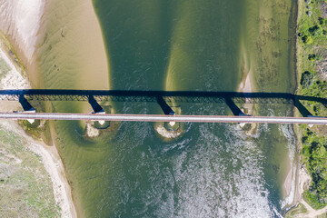 A bridge spans a river with a greenish tint