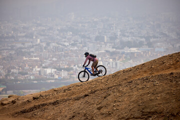 Fototapeta premium Carving down the epic trails of El Morro Solar. Whit the view of pacific Ocean and Lima on the background. Chorrillos, Lima, Peru