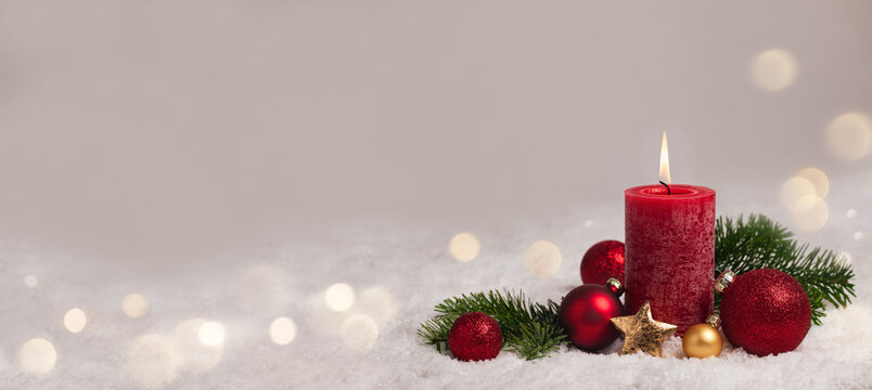Christmas Background - Red Candle in winter snow landscape background - Blank greeting card with magic golden bokeh lights with copy space for your Xmas Advent greeting card or advertisement, Panorama