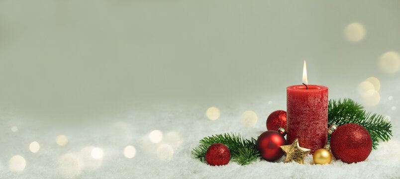 Christmas Background - Red Candle in winter snow landscape background - Blank greeting card with magic golden bokeh lights with copy space for your Xmas Advent greeting card or advertisement, Panorama