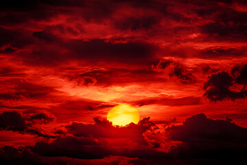 Fototapeta premium Bright red sunset. Dramatic evening sky with clouds. Fiery skies with space for design. Magic fantasy sky. War, battle, terror, world apocalypse, horror concept.