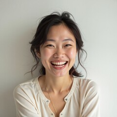 Fototapeta premium Woman beaming with joyful laughter against neutral background, happiness